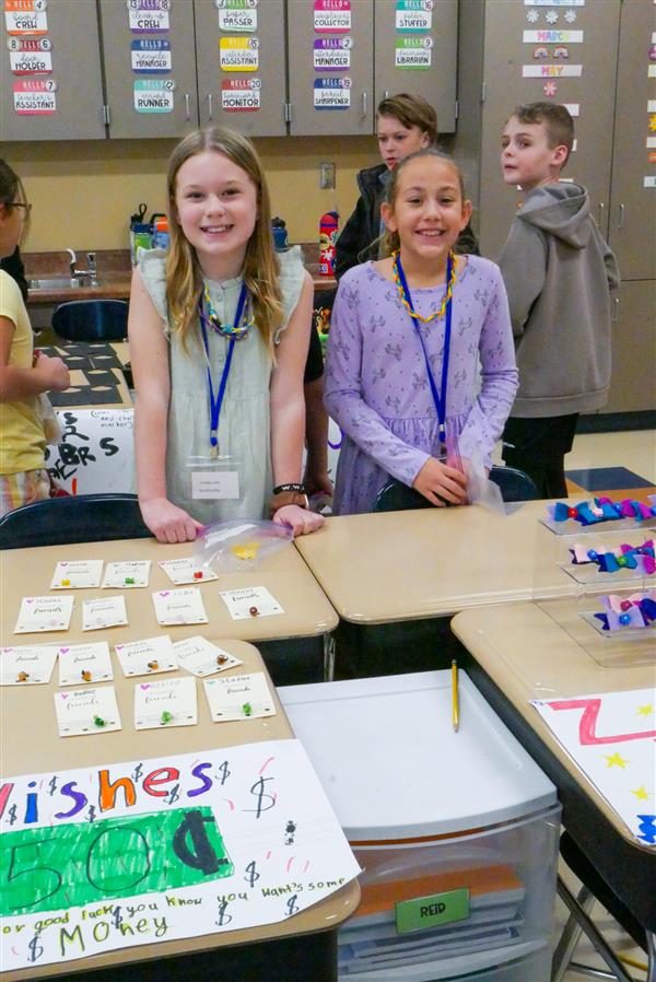two girls smiling in classroom